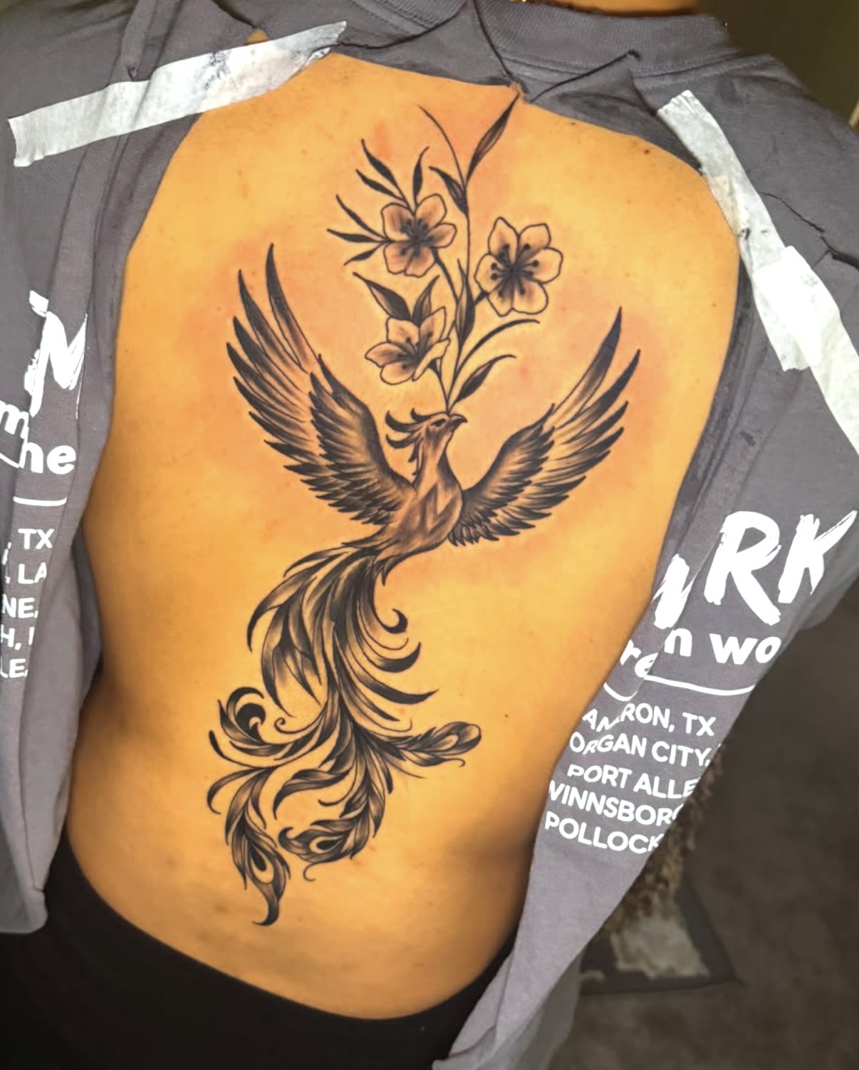 Black and gray phoenix and florals back piece by Erick