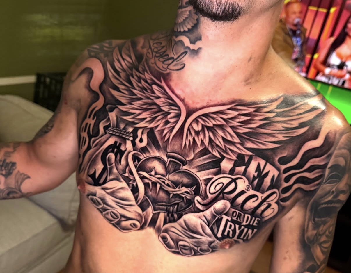 Black and gray winged sacred heart chest piece by Erick J. Haisley Sr.